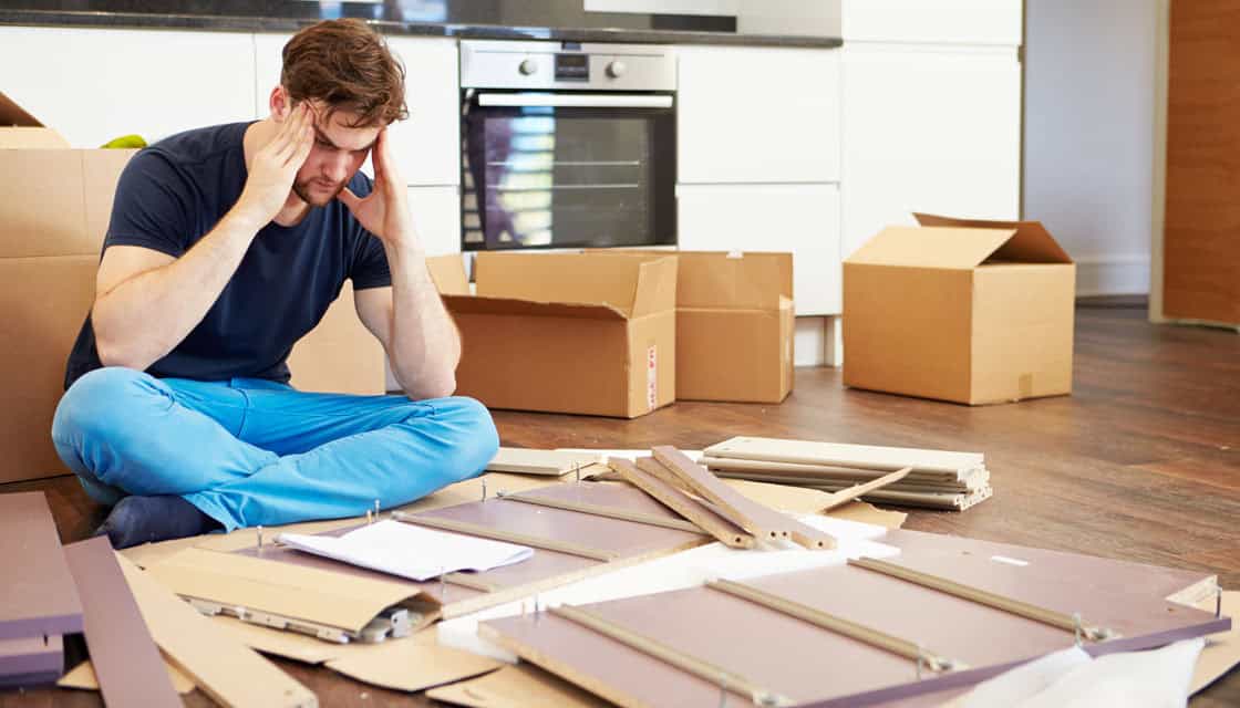 A man confused in putting together a self assembly furniture